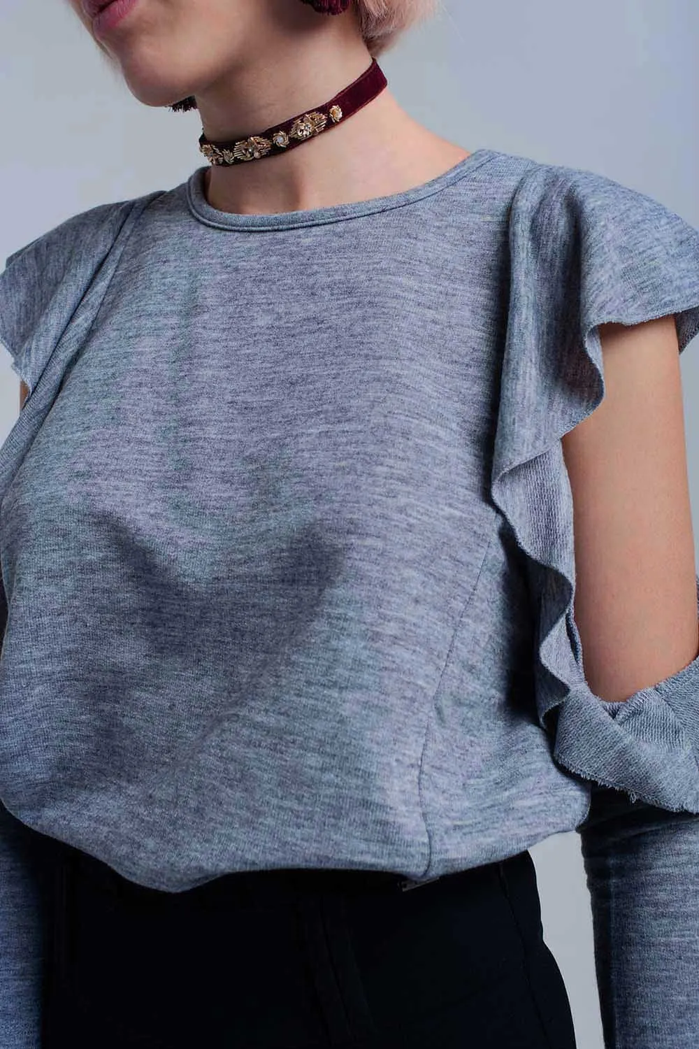 Gray top with ruffle and open detail